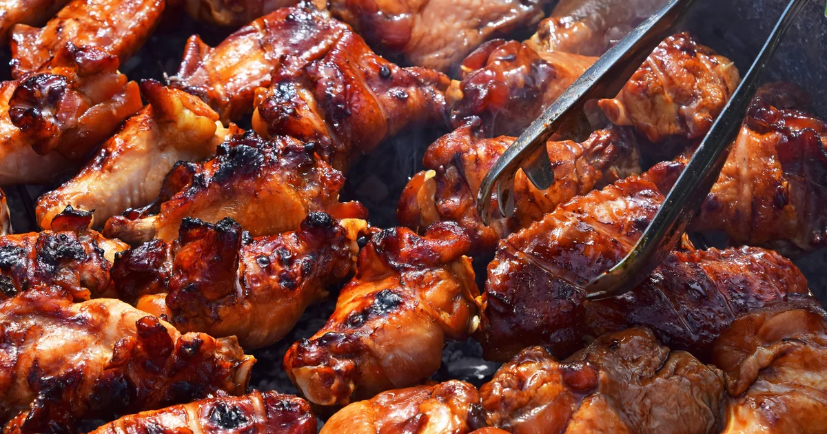 Chicken wings cooking on a barbecue grill